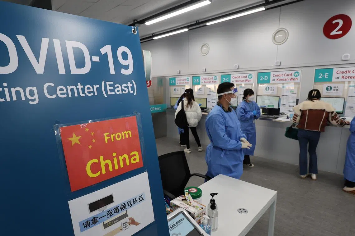 Entrants from China undergo procedures to receive Covid-19 tests at the Incheon International Airport on Jan 2, 2023.