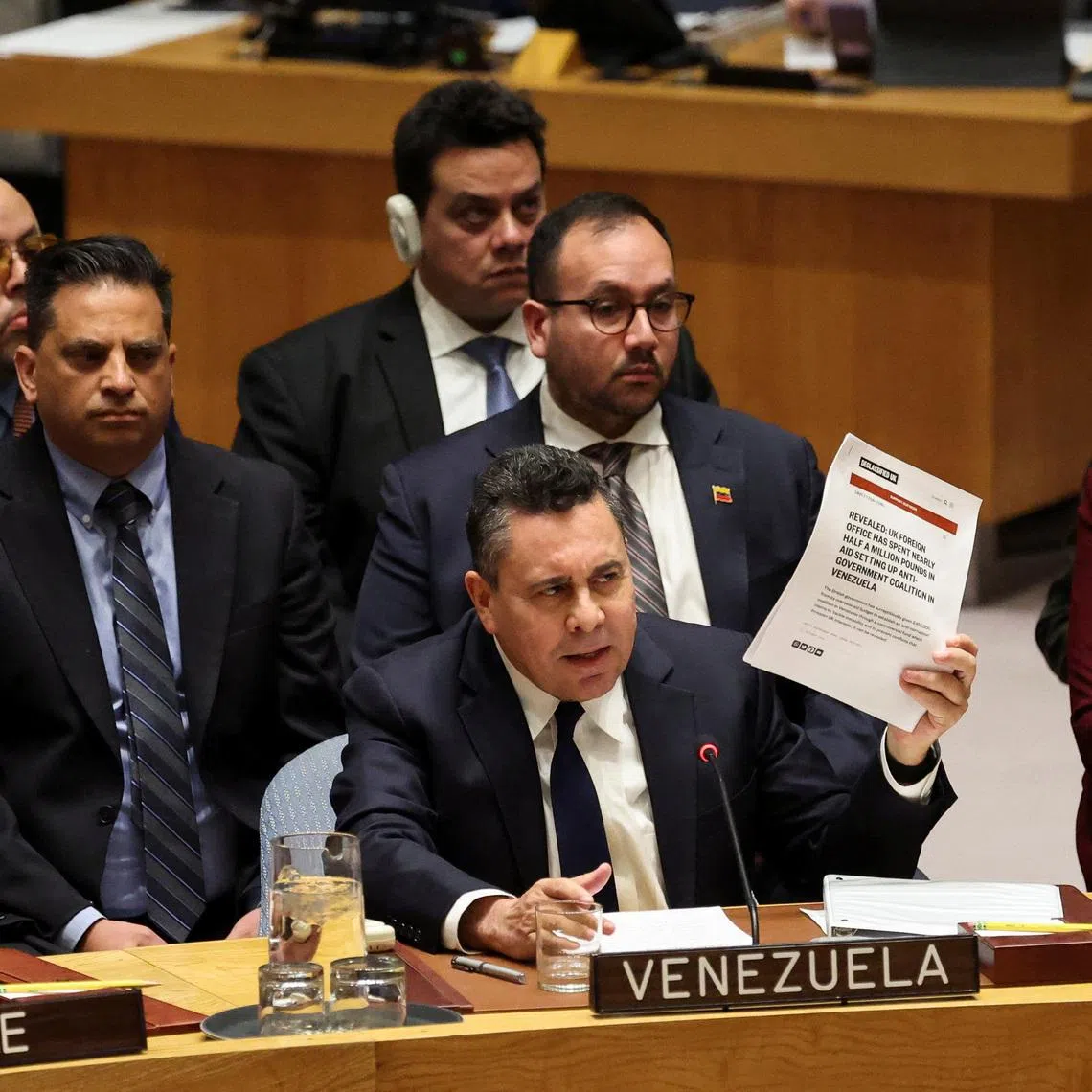Venezuela Ambassador to the United Nations Samuel Reinaldo Moncada Acosta speaks as he holds up a news article, during a UN Security Council meeting on U.S. strikes and the capture of Venezuelan President Nicolas Maduro and his wife, Cilia Flores, at the United Nations headquarters in New York, U.S., January 5, 2026. REUTERS/Brendan McDermid