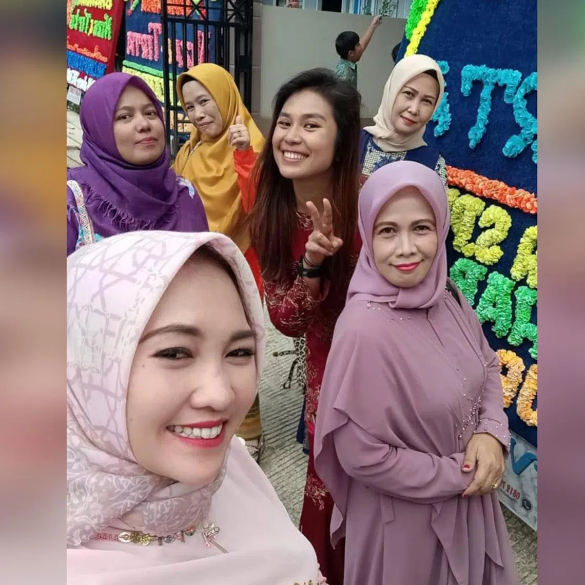 Ms Eileen Soh (in the middle, dressed in red) with wedding guests in May 2023 in the city of Sungai Penuh, Jambi province, in Indonesia. 