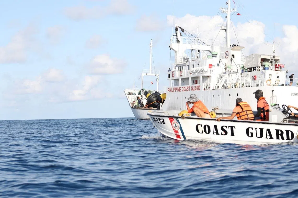 Philippine Coast Guard personnel installing navigational buoys in the Philippines' exclusive economic zone in the South China Sea. 