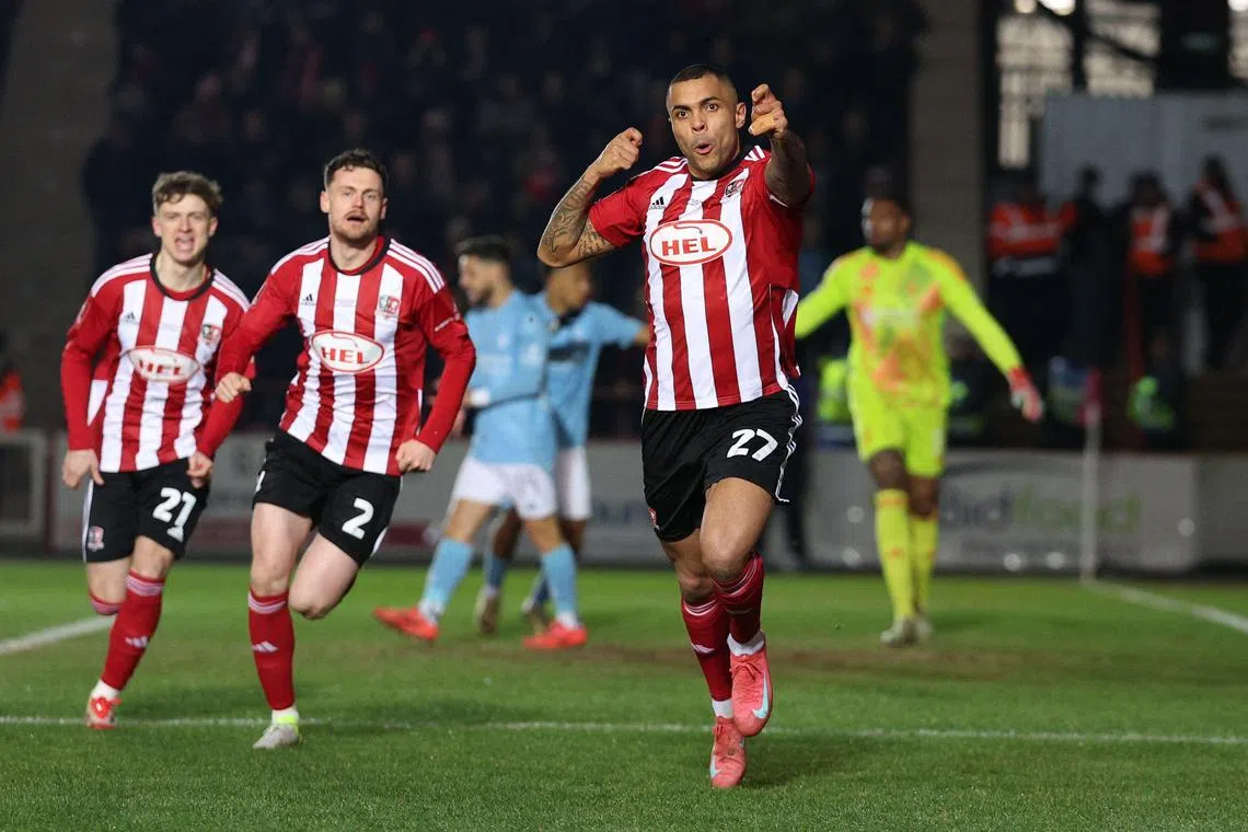 Exeter City striker Josh Magennis celebrates after scoring his team first goal during the English FA Cup fourth round match against Nottingham Forest at St James Park.