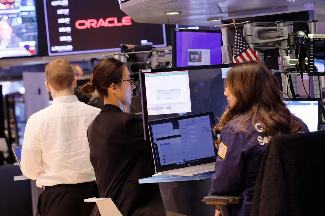 Traders work on the floor of the New York Stock Exchange, in New York City.