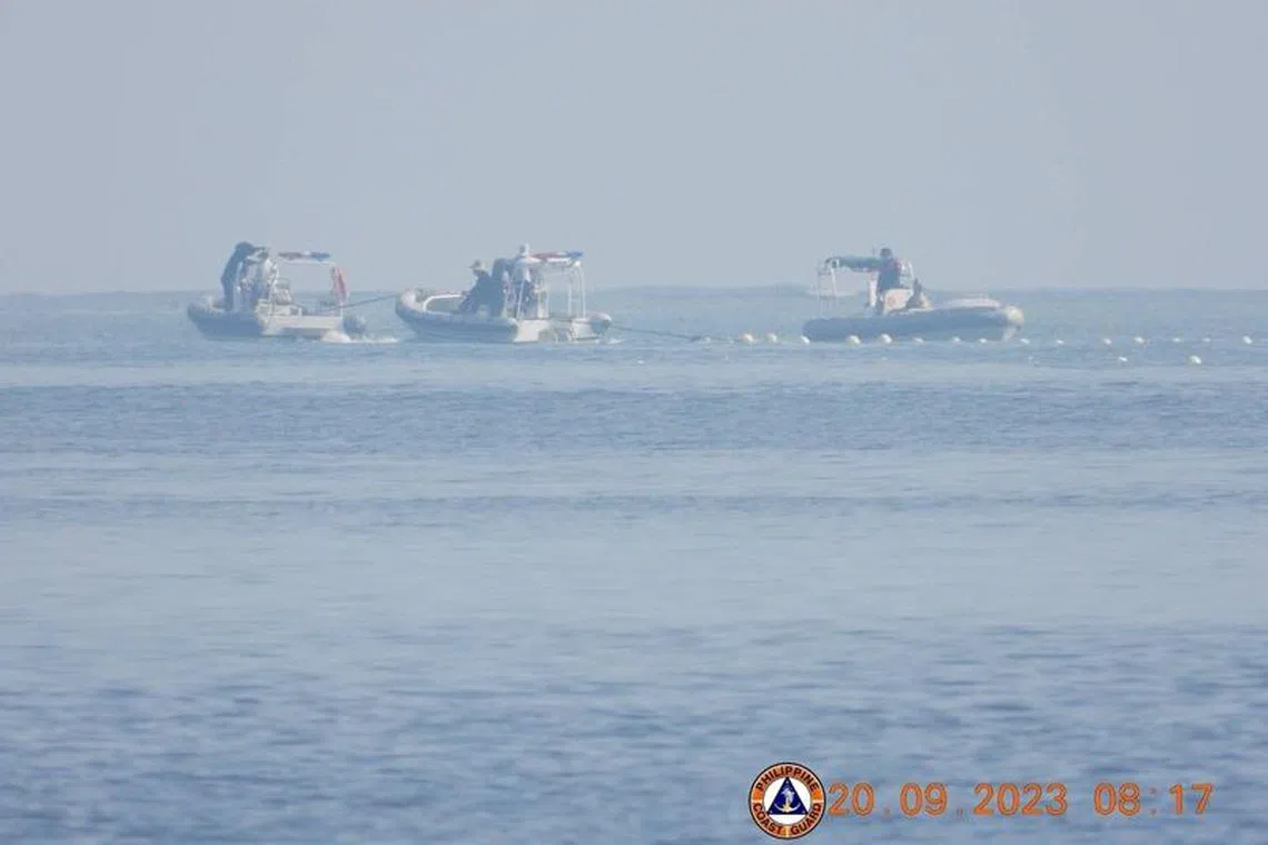 Chinese Coast Guard boats close to the floating barrier are pictured on September 20, 2023, near the Scarborough Shoal in the South China Sea, in this handout image released by the Philippine Coast Guard on September 24, 2023. Philippine Coast Guard/Handout via REUTERS