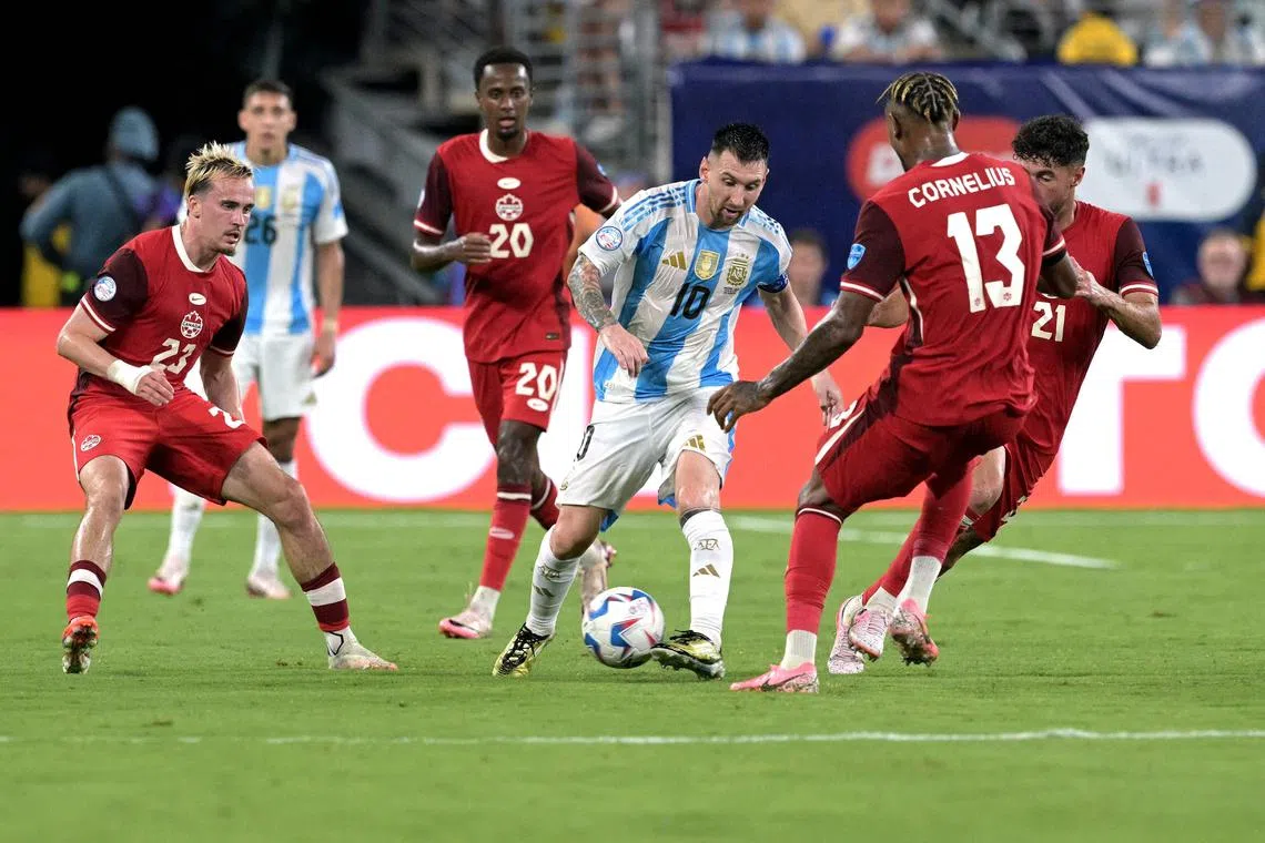 Argentina captain Lionel Messi fighting for the ball with Canada's Liam Millar (No. 23), Ali Ahmed (20), Derek Cornelius (13) and Jonathan Osorio (21) during the Albiceleste's 2-0 Copa America semi-final win at MetLife Stadium in East Rutherford, New Jersey, on July 9.