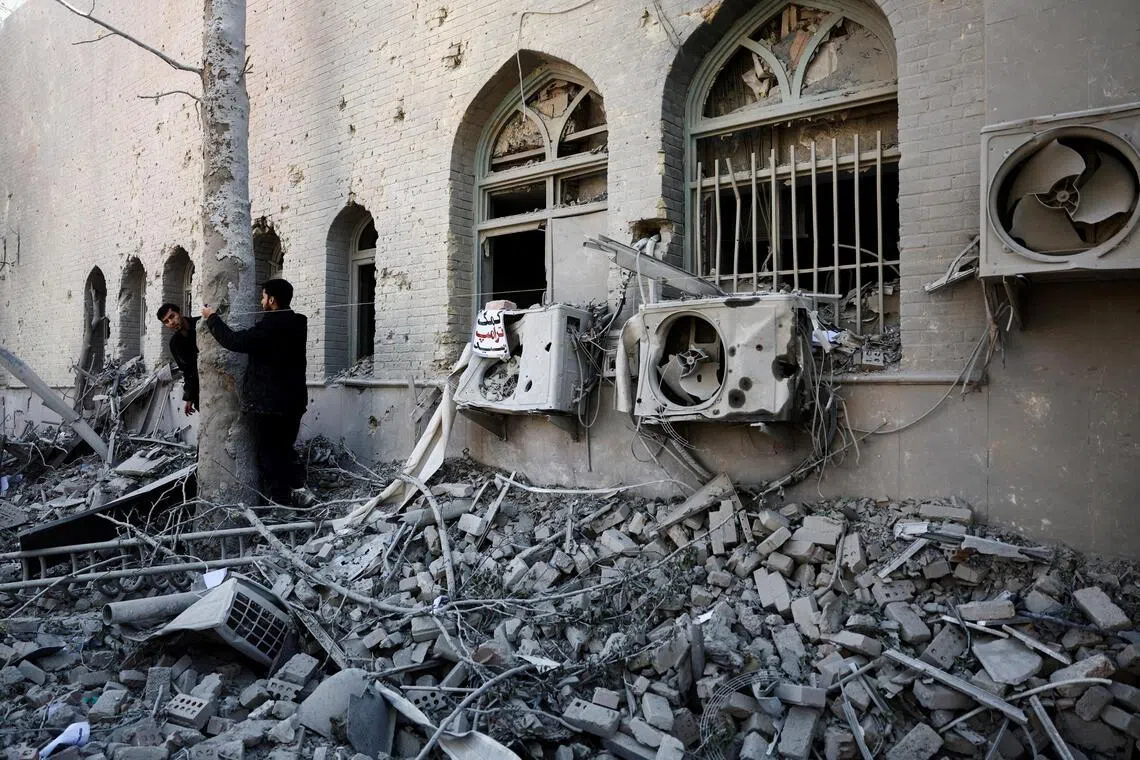 People stand amidst the rubble of a building of the Sharif University of Technology, which was damaged in a strike, amid the US-Israeli conflict with Iran, in Tehran. US-Israeli strikes hit the university in Isfahan, which is among the largest universities in Iran, in March.