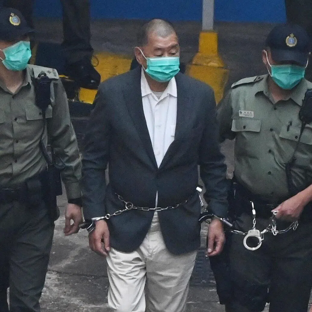 Hong Kong pro-democracy media tycoon Jimmy Lai was led into a police van as he headed to court to be charged under the territory's controversial new national security law in Hong Kong on Dec 12, 2020.