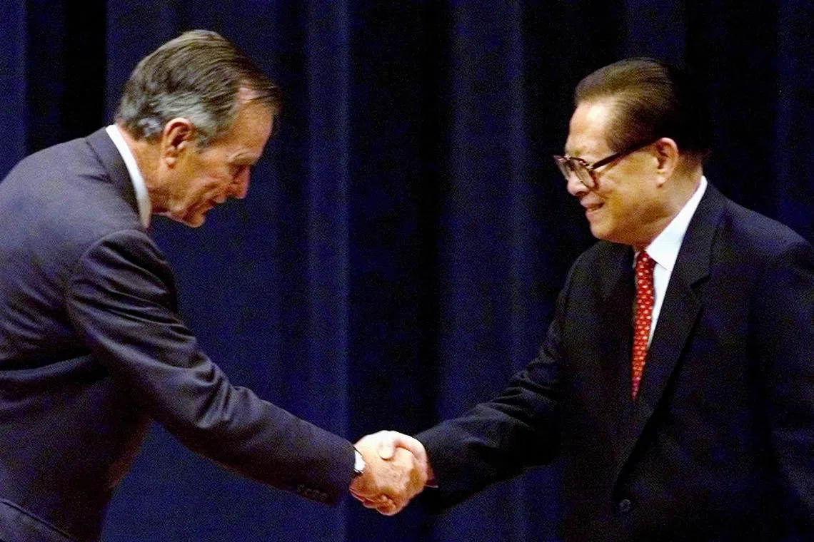 China's President Jiang Zemin and former U.S. president George Bush shake hands after Jiang was introduced at the George Bush Presidential Library in College Station, Texas, U.S. on Oct 24, 2002. 