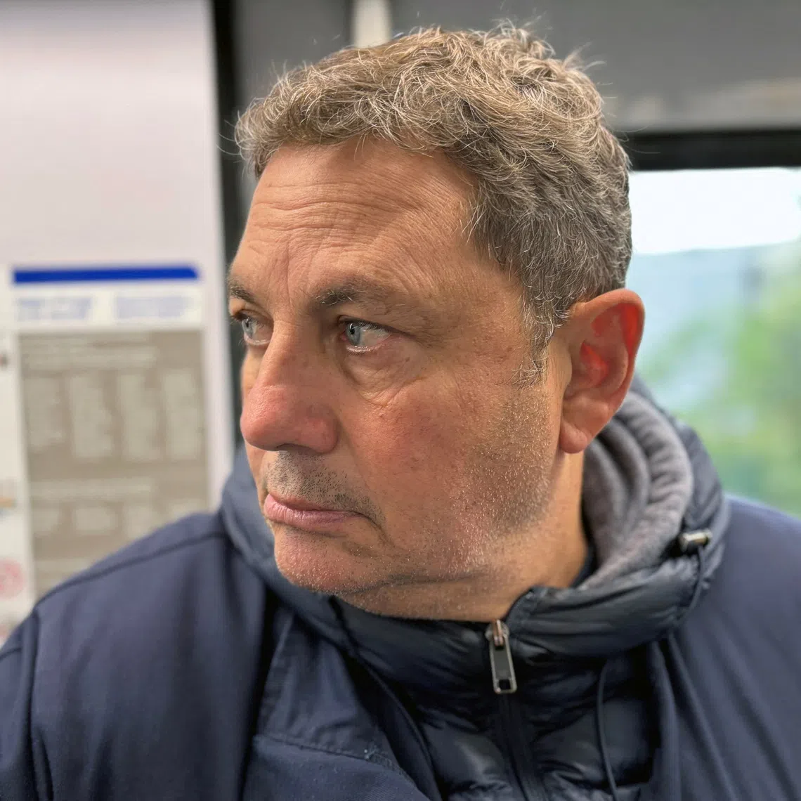 Fabrice Lehmann, a private detective who increasingly tracks white-collar workers suspected of abusing sick leave, follows a target believed to be working for another company while off sick, on a commuter train, in Paris, France, September 16, 2025.  REUTERS/Gabriel Stargardter