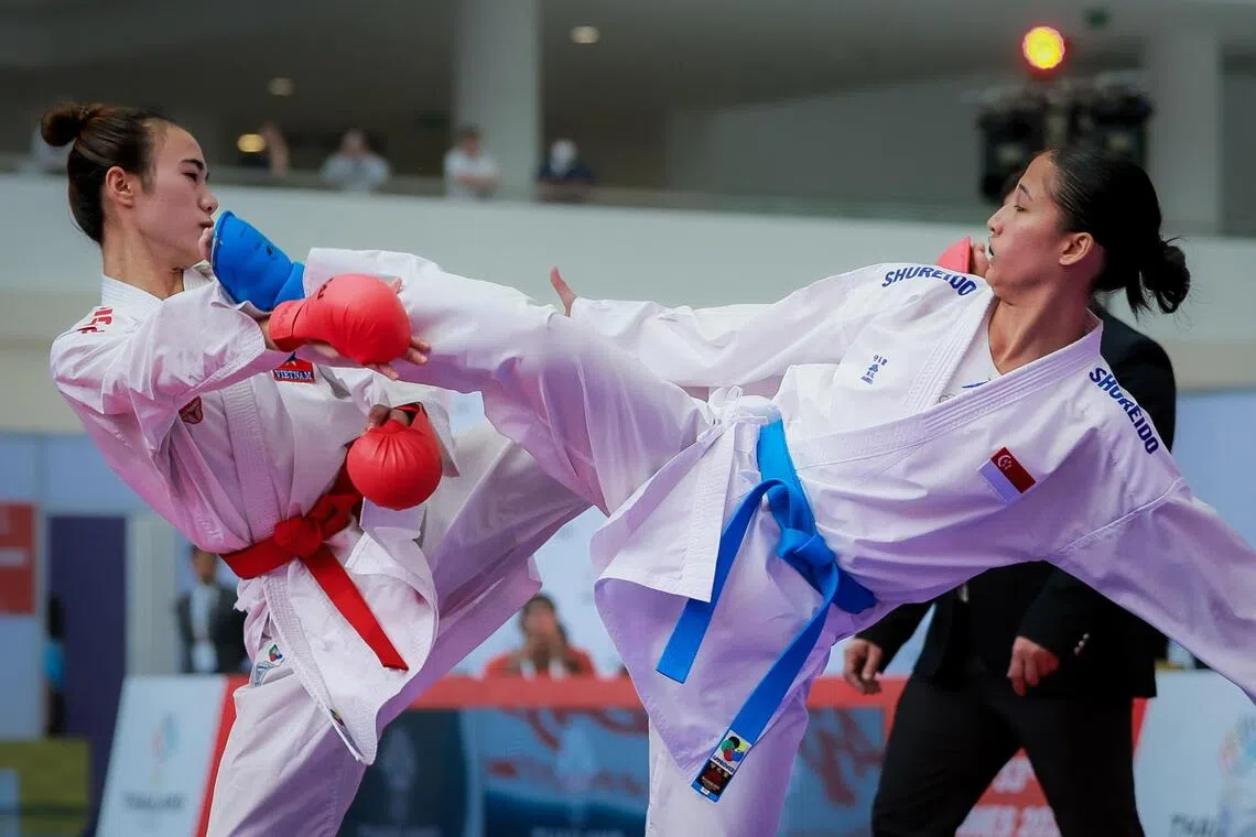 Singapore’s Marissa Hafezan (right) landing a kick against Vietnam’s Nguyen Thi Dieu Ly in the karate women’s kumite 55kg final at the Chaeng Watthana Government Complex in Bangkok on Dec 12.