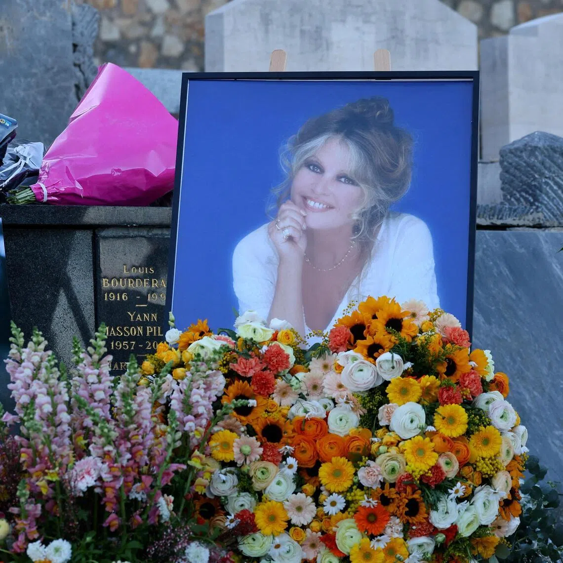 Flowers and photos near the grave of Brigitte Bardot, after her funeral ceremony in Saint-Tropez, France, on Jan 7.