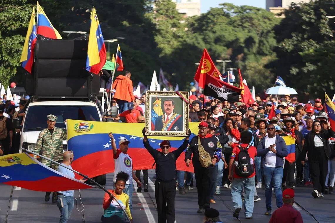 Several demonstrators, many of them public sector workers, held photos of Nicolas Maduro and his wife Cilia Flores.