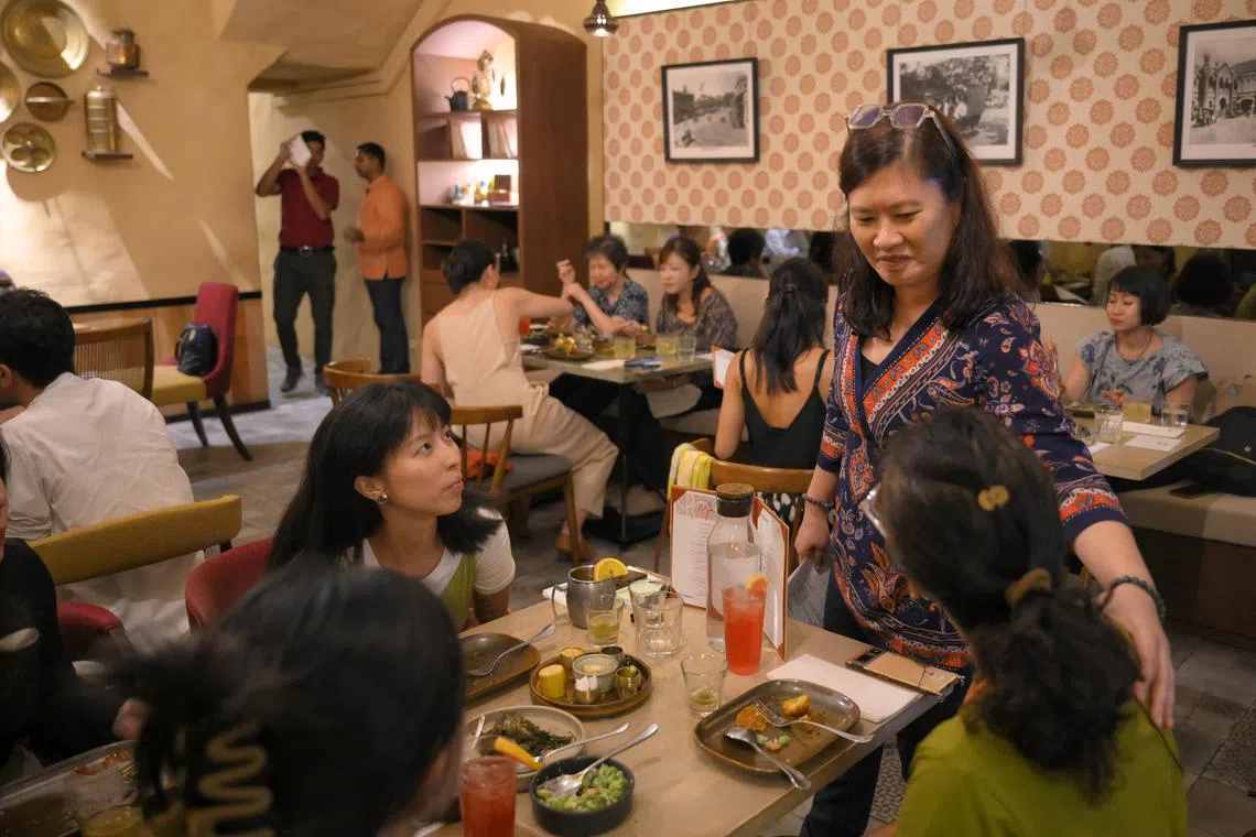 Participants at The Life Review's Death over Dinner discuss touchy topics under the guidance of Ms Tan Ming Li (standing). 