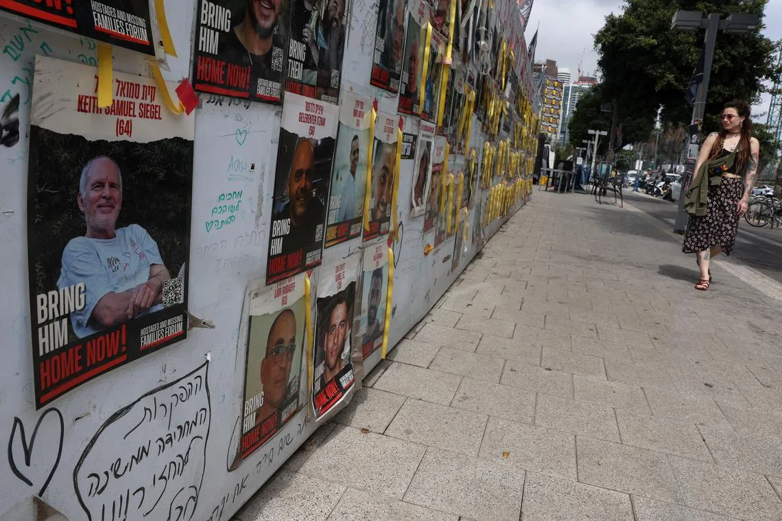 FILE PHOTO: A view of a banner depicting Keith Siegel, who is a dual U.S. citizen seized during the October 7 attack on Israel and taken hostage into Gaza, amid the ongoing conflict between Israel and Hamas, is seen with other images of hostages in Tel Aviv, Israel, April 28, 2024. REUTERS/Shannon Stapleton/File Photo