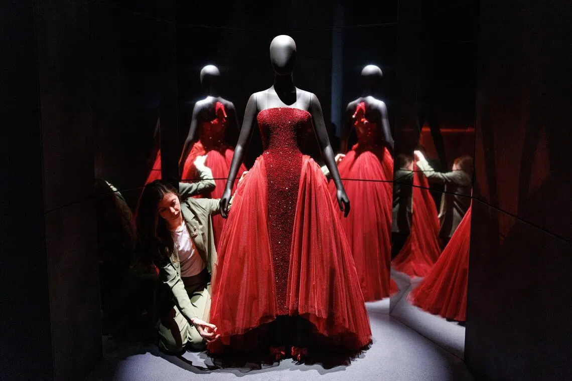 epa12847433 A gallery staff poses with the Custom Schiaparelli Haute Couture dress worn by US singer-songwriter and actor Ariana Grande at the 97th Academy Awards ceremony, during a press preview for the upcoming exhibition 'Schiaparelli: Fashion Becomes Art' at Victoria and Albert Museum in London, Britain, 24 March 2026. The first-ever UK exhibition that explores the work of legendary Italian fashion designer Elsa Schiaparelli from the 1920s to today, celebrating the innovative designer's influence and her surrealist legacy, will run from 28 March until November 2026.  EPA/TOLGA AKMEN