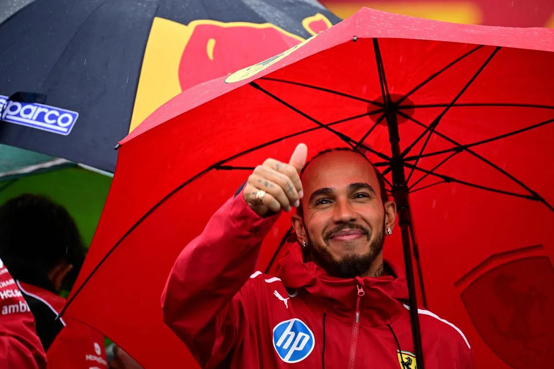 Ferrari's Lewis Hamilton waves to fans during the drivers parade before the British Grand Prix.