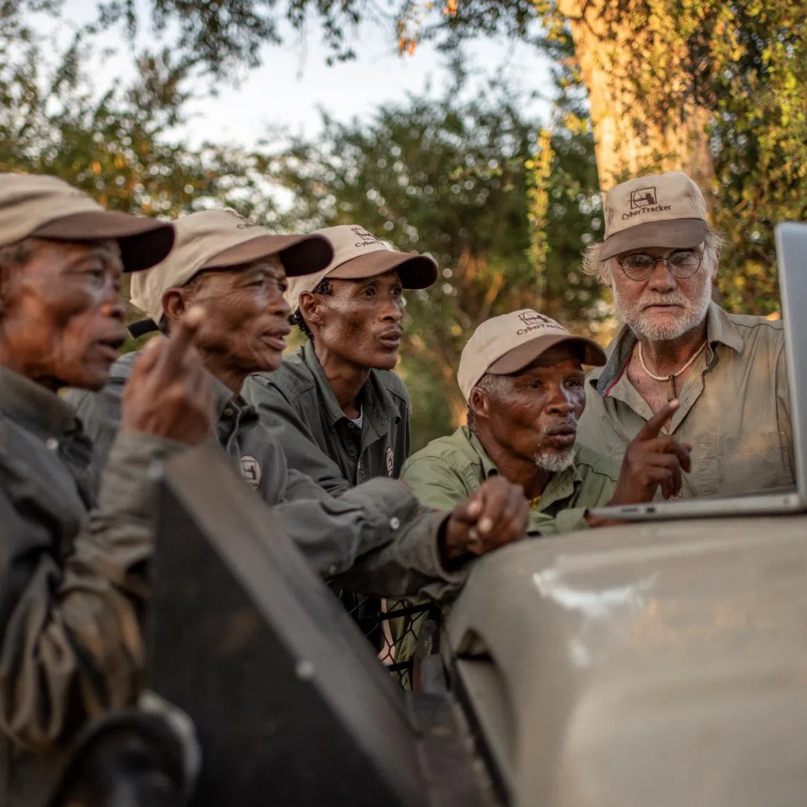 Indigenous animal trackers and Louis Liebenberg look at CyberTracker dashboard