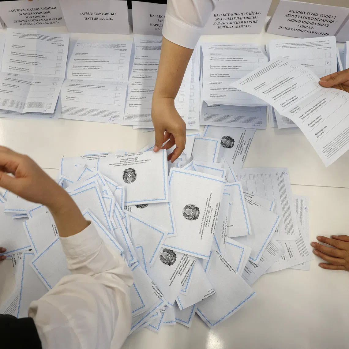 Members of a Kazakh electoral commission count votes after polling stations closed on the day of a parliamentary election in Almaty, Kazakhstan, August 23, 2026. REUTERS/Pavel Mikheyev