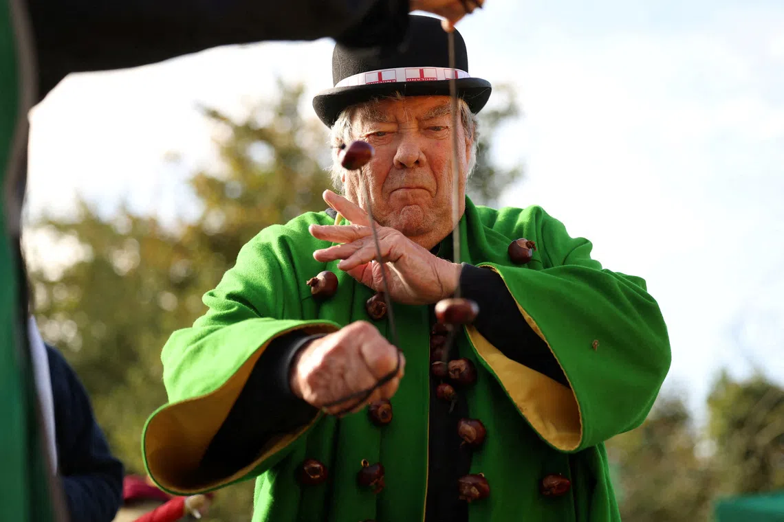 FILE PHOTO: David Jakins, known as 'King Conker', takes part in the annual World Conker Championships in Southwick, Britain, October 13, 2024. REUTERS/Phil Noble/File Photo