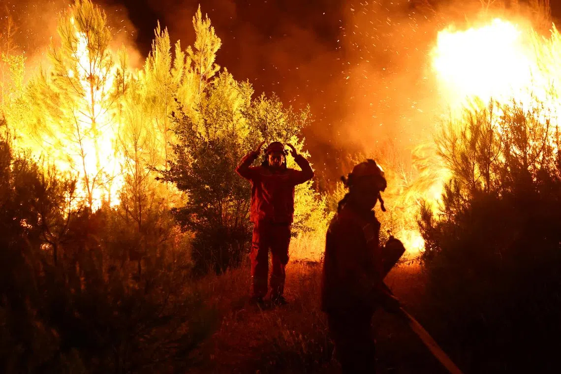 Members of emergency services working to contain a wildfire in Shengjin, Albania, on July 30, 2024. 