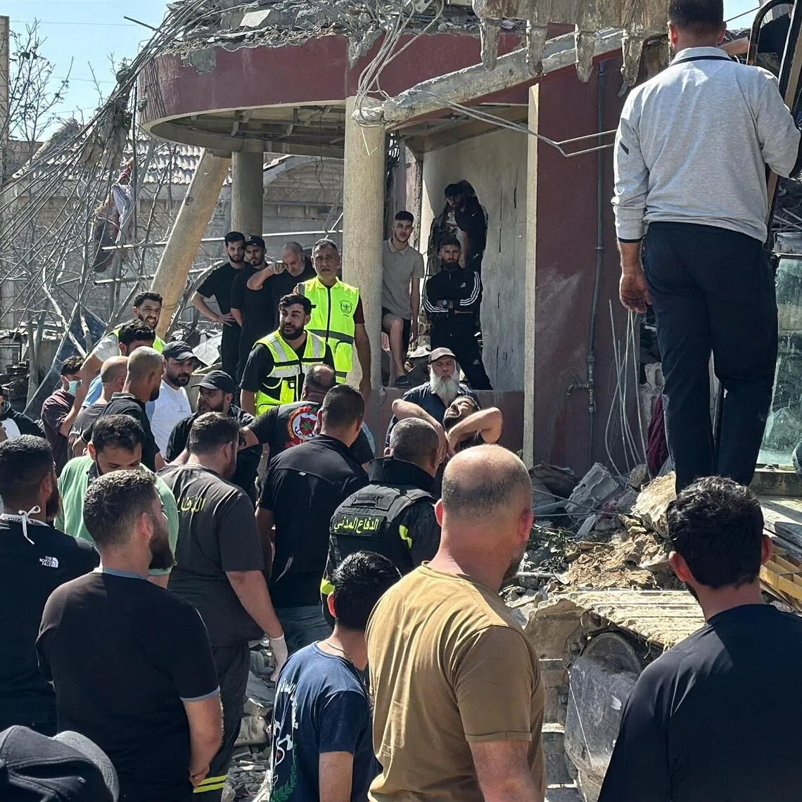 Emergency responders, assisted by members of the public and heavy machinery, inspecting the site of an Israeli strike in Saksakiyeh, Lebanon, on May 9.