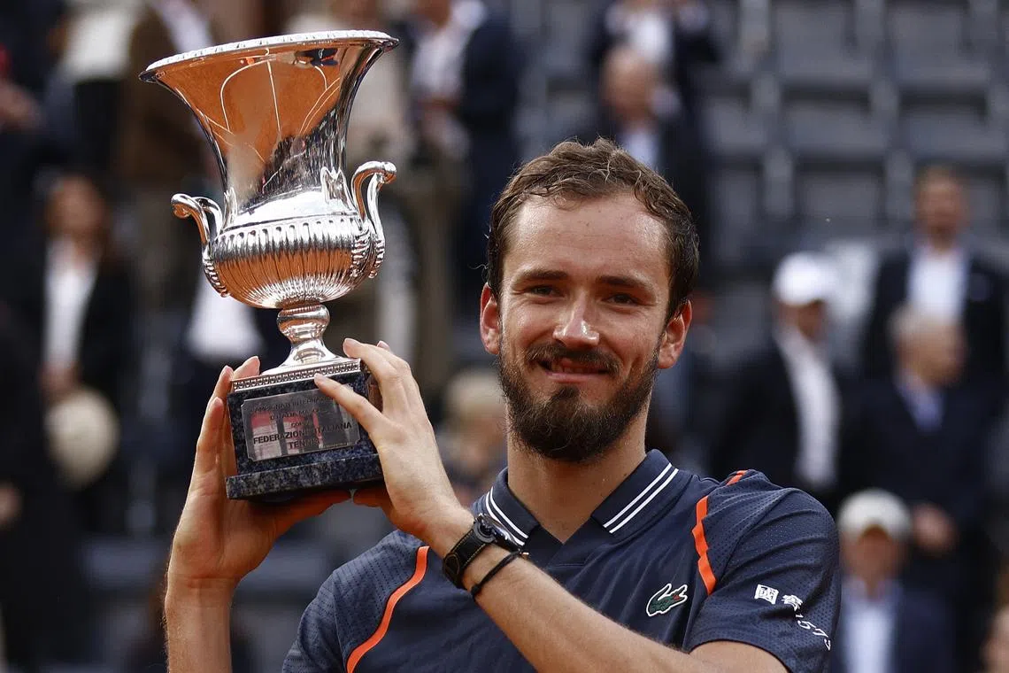 Russia's Daniil Medvedev poses with the trophy after winning the men's singles final against Denmark's Holger Rune.