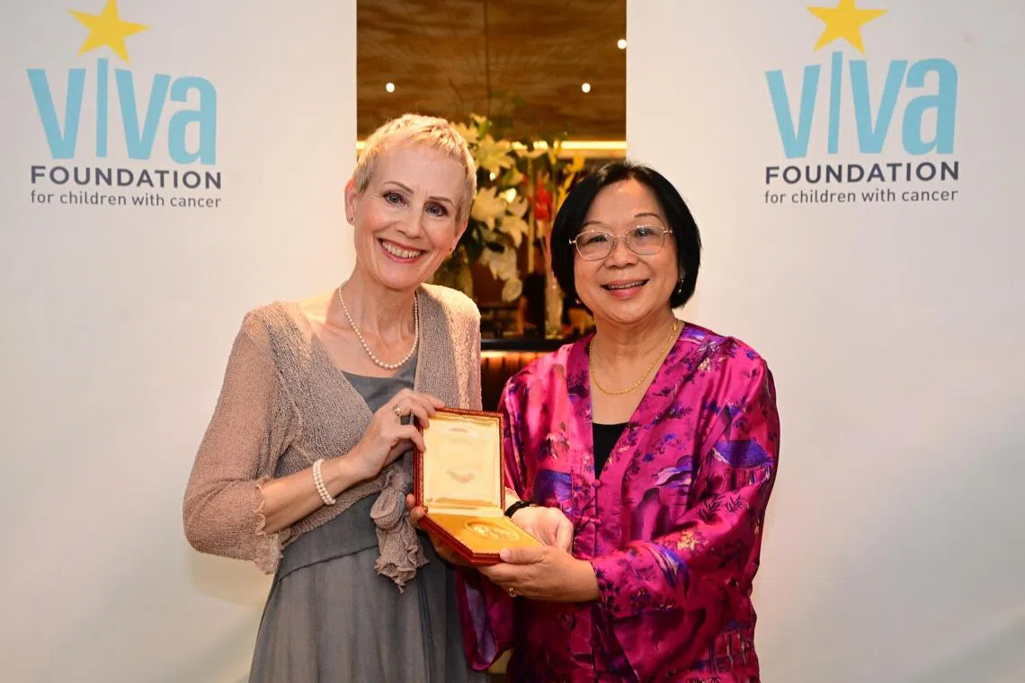 Ms Carla Brenner, daughter of Dr Sydney Brenner, South African biologist and Nobel Prize winner, presents Dr Brenner’s medal to Ms Jennifer Leong, chairperson of Viva Foundation for Children with Cancer during the launch of Yayasan Viva Indonesia on Nov 28. 

ST PHOTO: AZMI ATHNI