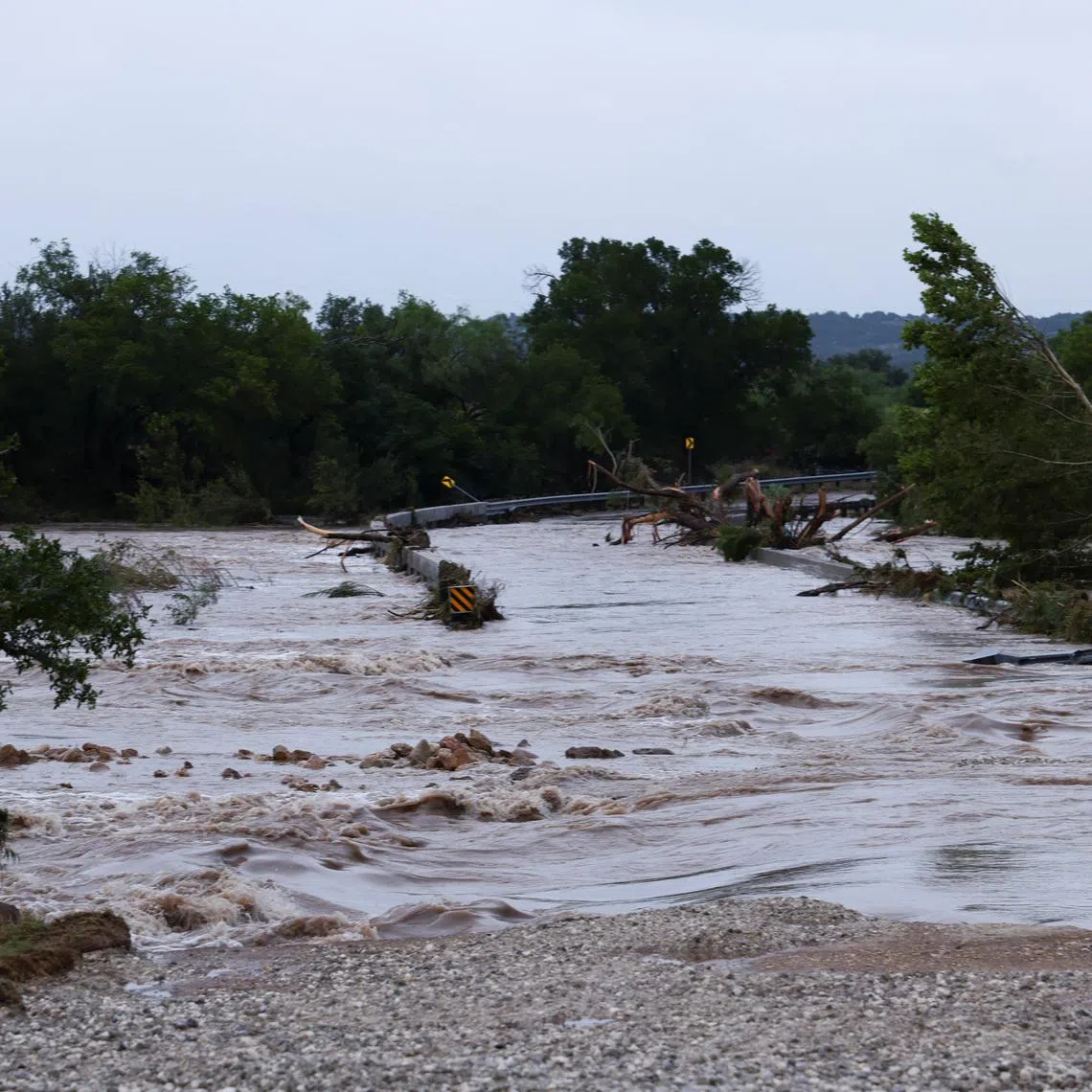 The Pedernales River rises over Old San Antonio Road as heavy rains and severe weather hit southern Texas near Fredericksburg, Texas, U.S., July 16, 2026. REUTERS/Kaylee Greenlee