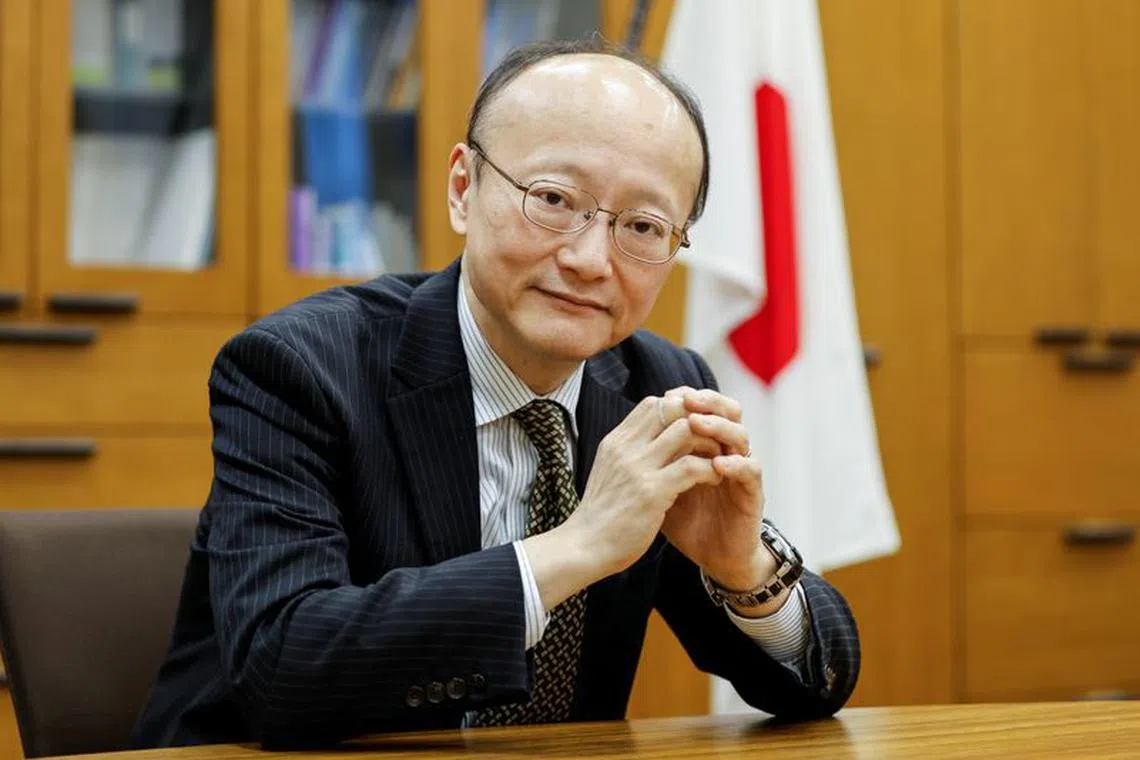 FILE PHOTO: Japan's vice minister of finance for international affairs, Masato Kanda, poses for a photograph during an interview with Reuters at the Finance Ministry in Tokyo, Japan January 31, 2022. Picture taken January 31, 2022.  REUTERS/Issei Kato/File photo