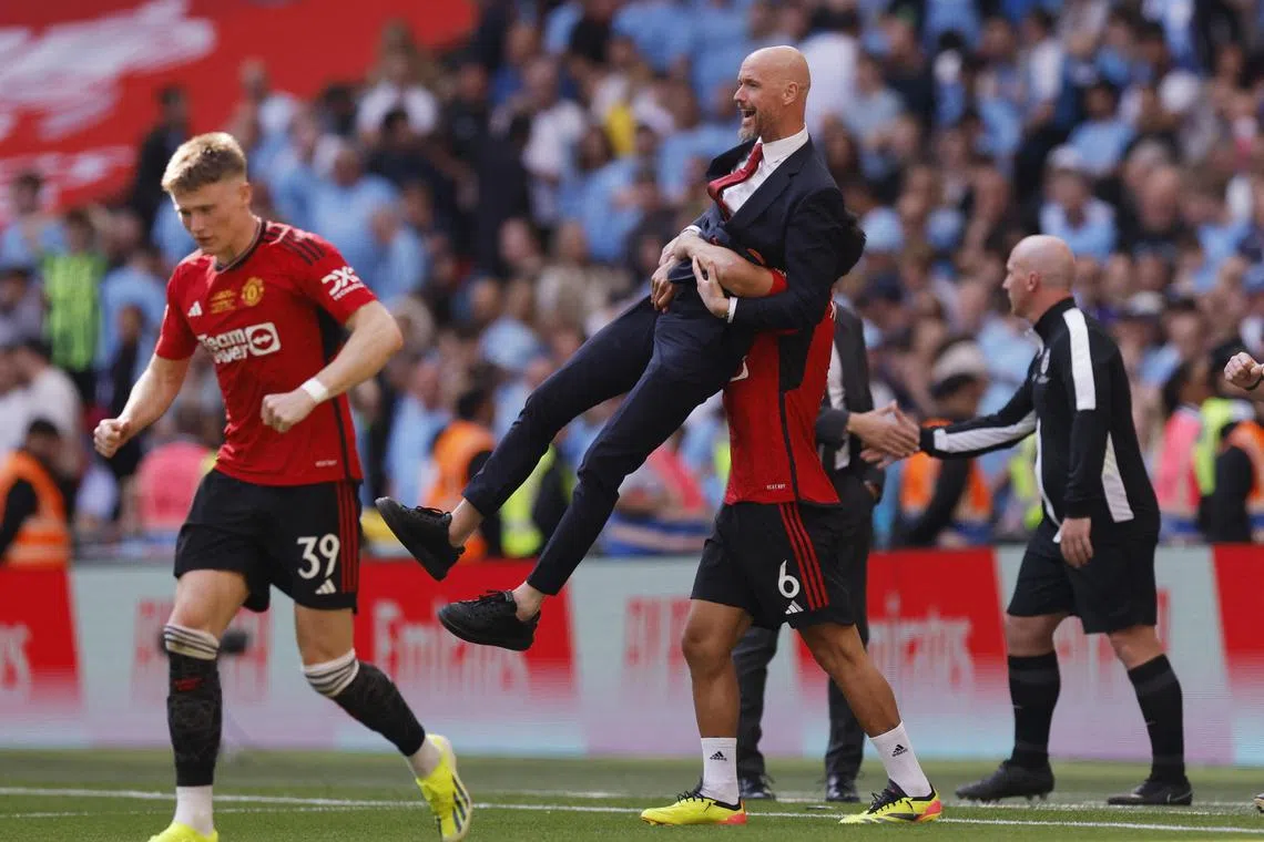 Manager Erik ten Hag getting a celebratory lift from player Lisandro Martinez after Manchester United beat Manchester City to win the FA Cup on May 25.