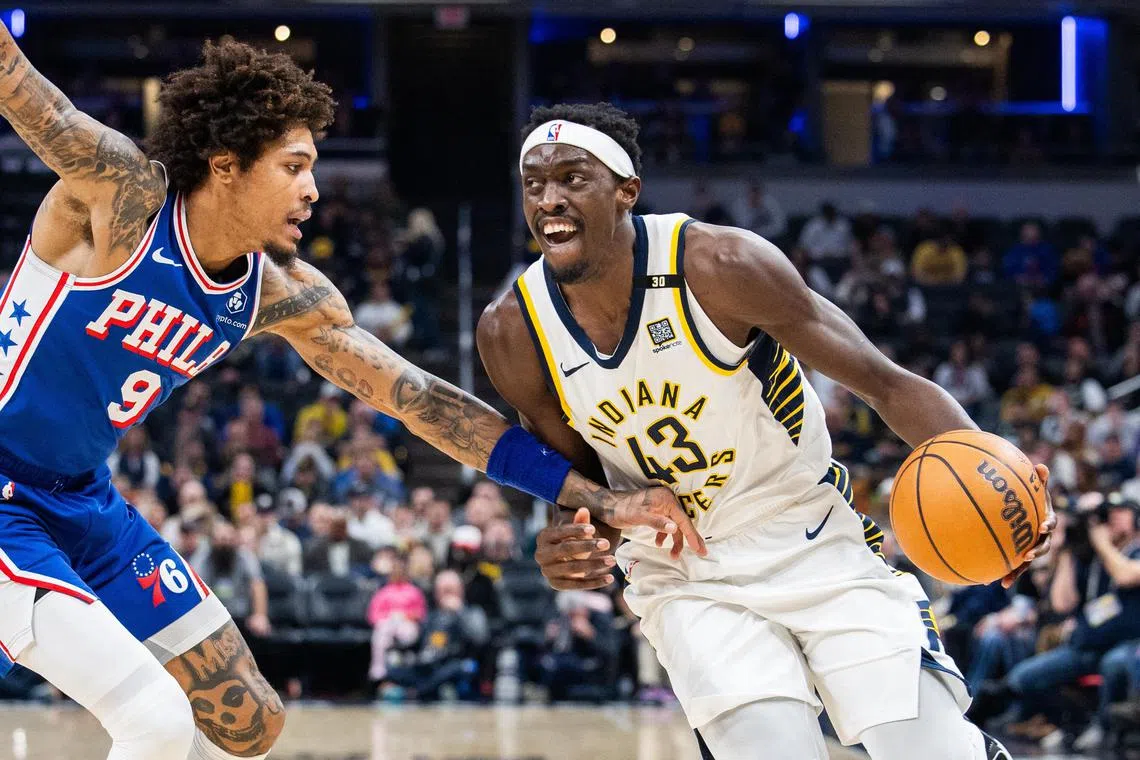 Indiana Pacers forward Pascal Siakam dribbles the ball while Philadelphia 76ers guard Kelly Oubre Jr. defends in the first half at Gainbridge Fieldhouse.