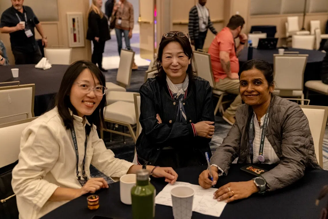 ang, left, during a discussion with peers from india and japan under microsoft’s code without barriers initiative tech skills accelerator in singapore
