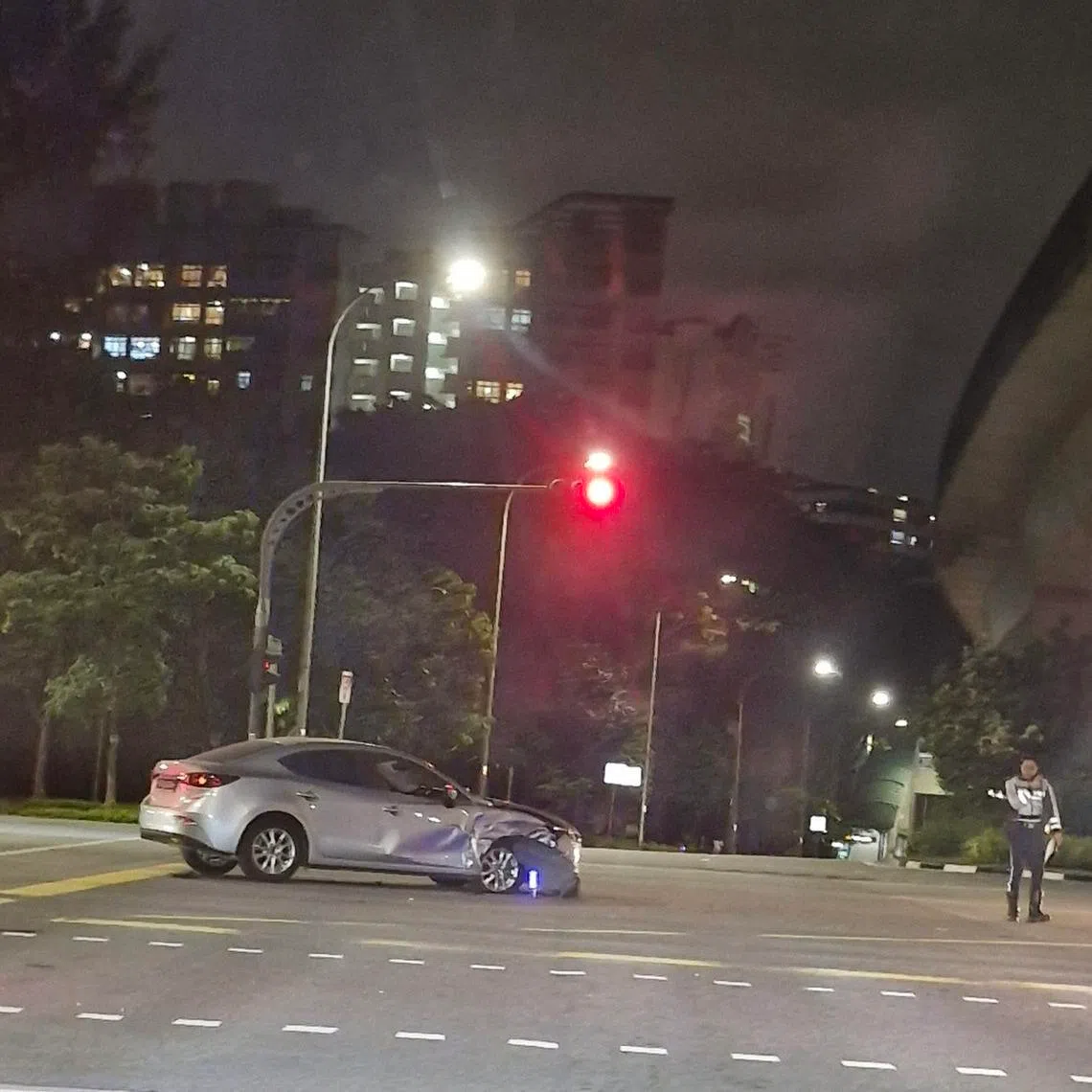 A visibly dmaaged silver sedan after an accident in Punggol on Jan 23.