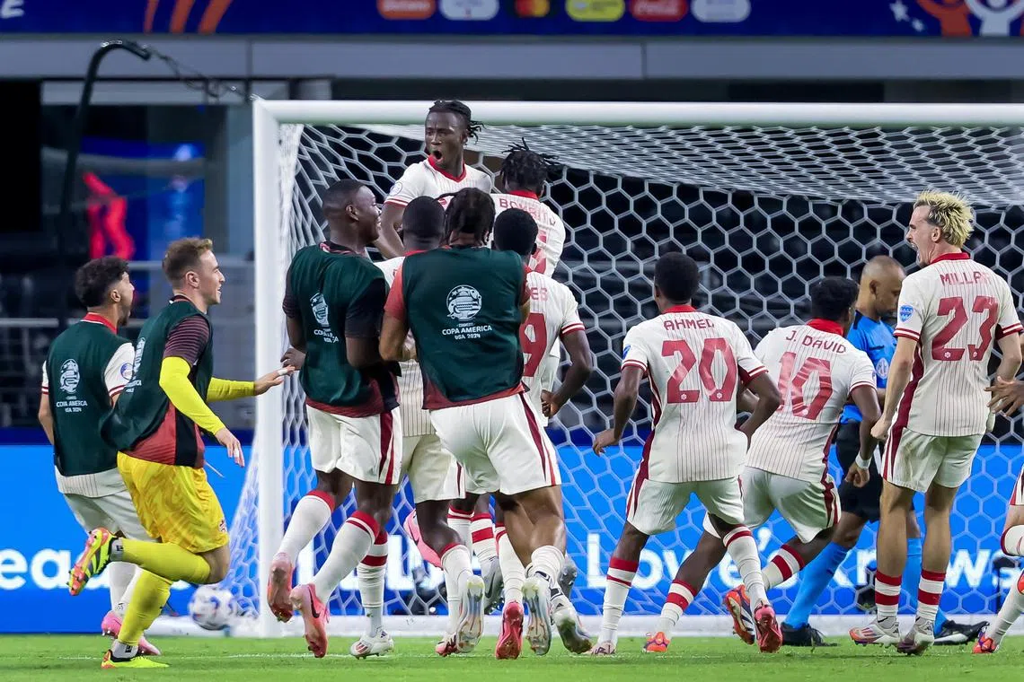 Ismael Kone (centre) being mobbed by his teammates after the Canada midfielder buried the winning penalty against Venezuela on July 5 to send his side through to the Copa America semi-finals.