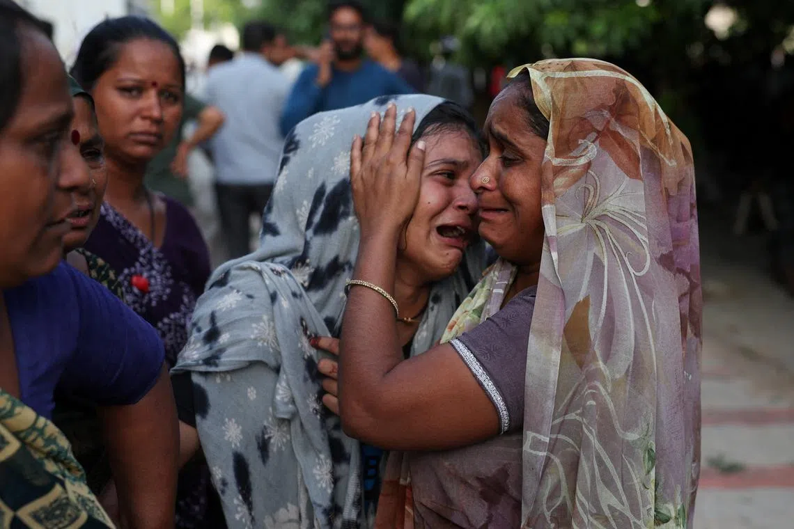 A family member in tears upon hearing the news of her brother, who died when the Air India Boeing 787 Dreamliner plane crashed in Ahmedabad, India, on June 12, 2025. 