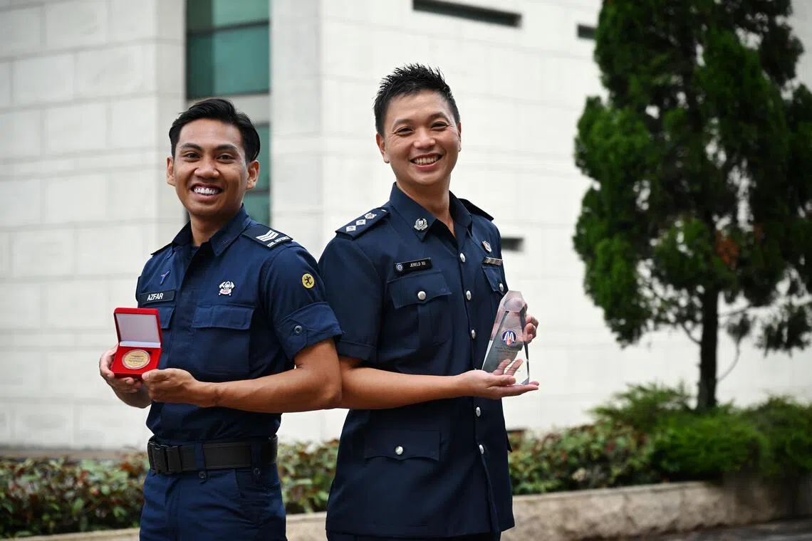 SCDF volunteer, Muhammad Azfar Mazlan (left) and Superintendent of Police, Jereld Xu, Deputy Head, Organised Crime Branch Specialised Crime Division, Criminal Investigation Department at the Home Team National Day Observance Ceremony 2026, on July 29.