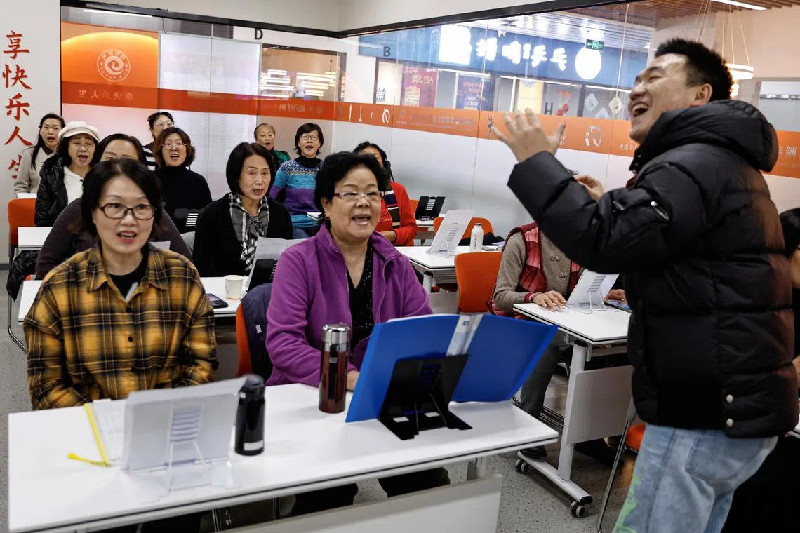 Women attend a singing class at Mama Sunset, a learning centre for middle-aged and senior people in Beijing, China January 17, 2024. REUTERS/Tingshu Wang