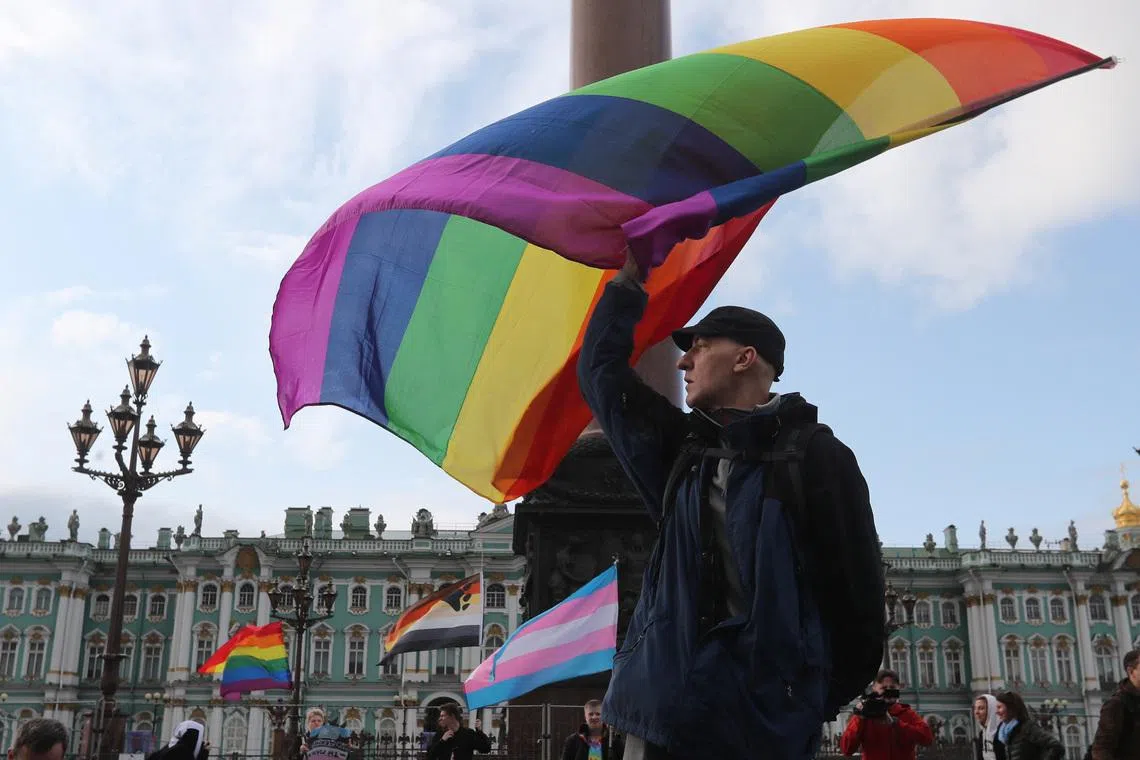 A participant waves a rainbow flag during the LGBT community rally \"X St.Petersburg Pride\" in central Saint Petersburg, Russia August 3, 2019. REUTERS/Anton Vaganov