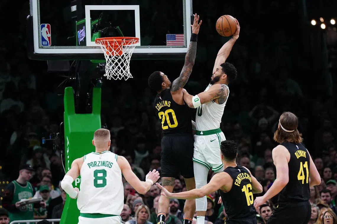 Boston Celtics forward Jayson Tatum trying to score against Utah Jazz forward John Collins in the second half at TD Garden. 