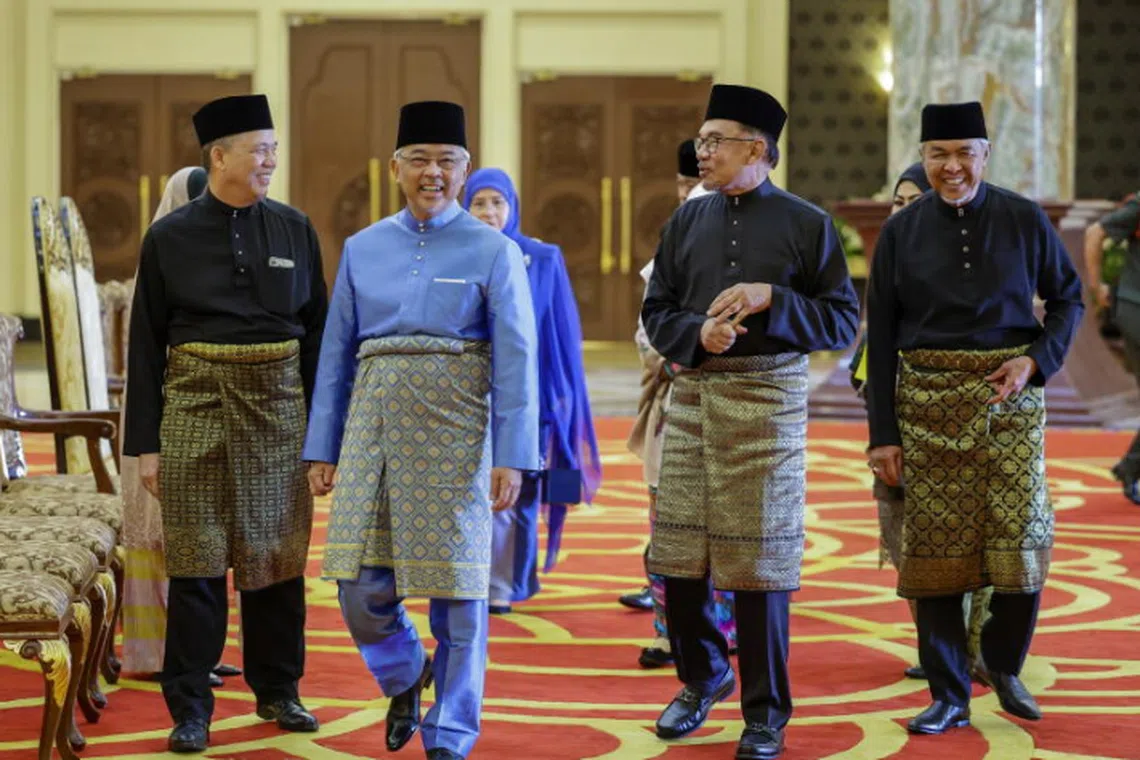 Malaysia's Sultan Abdullah (second from left), PM Anwar (third from left), with Deputy PM Fadillah Yusof (extreme left) and Deputy PM Zahid Hamidi (extreme right) at the national palace on Dec 2.