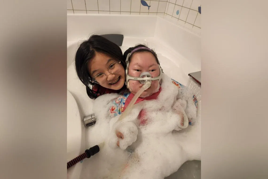 Amanda Ng has been caring for her sister Amelia, who has a rare genetic disorder that has since robbed her of the ability to talk, chew or urinate.