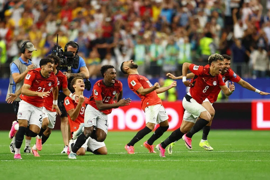 Soccer Football - FIFA World Cup 2026 - Round of 32 - Australia v Egypt - Dallas Stadium, Arlington, Texas, U.S. - July 3, 2026
Egypt players celebrate after Hossam Abdelmaguid scores the penalty past Australia's Mathew Ryan to win the shoot-out as Egypt qualify for the Round of 16 stage of the World Cup REUTERS/Hannah Mckay     TPX IMAGES OF THE DAY