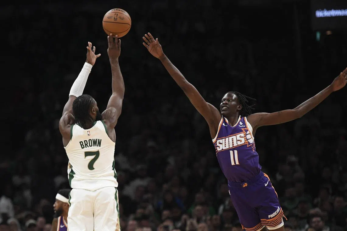 Boston Celtics forward Jaylen Brown shoots the ball over Phoenix Suns centre Bol Bol during the first half at TD Garden.