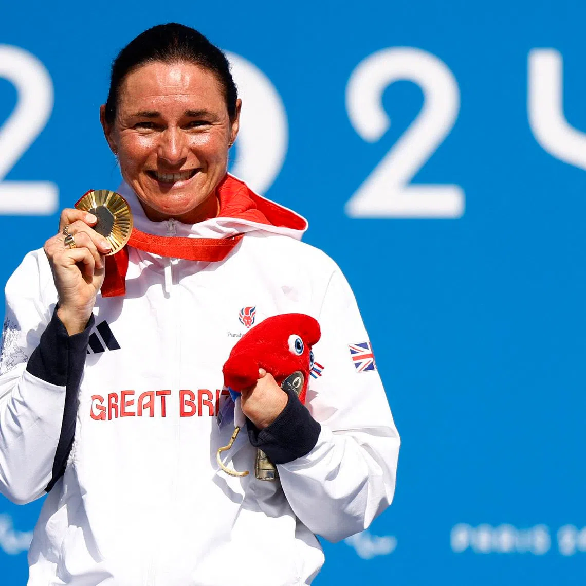 Paris 2024 Paralympics - Road Cycling - Women's C4-5 Road Race - Victory Ceremony - Clichy-sous-Bois, France - September 6, 2024 Sarah Storey of Britain celebrates on the podium after winning the gold medal. REUTERS/Maria Abranches