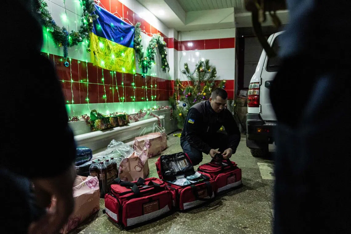 A Ukrainian firefighter receives New Year's gifts at their station in the city of Bakhmut, eastern Ukraine, on Dec 31, 2022. 