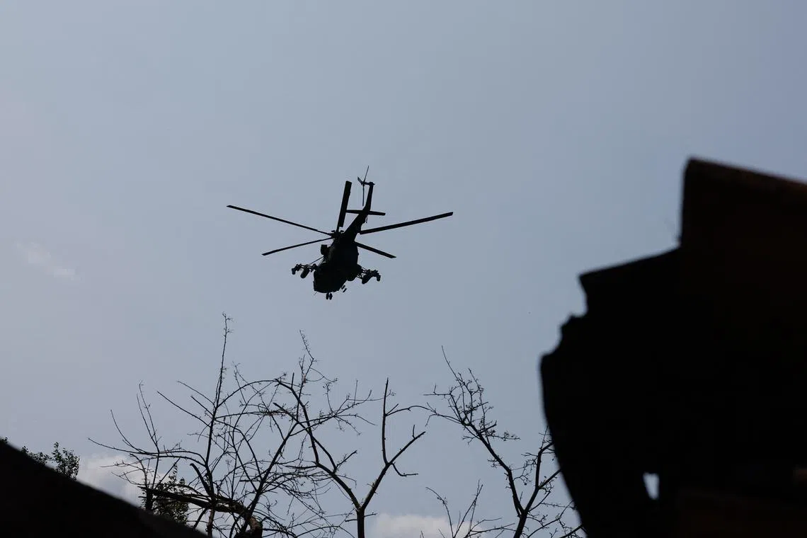 A Russian military helicopter flies in the sky, in the course of Russia-Ukraine conflict in the Donetsk Region, a Russian-controlled area of Ukraine, June 14, 2025. REUTERS/Alexander Ermochenko
