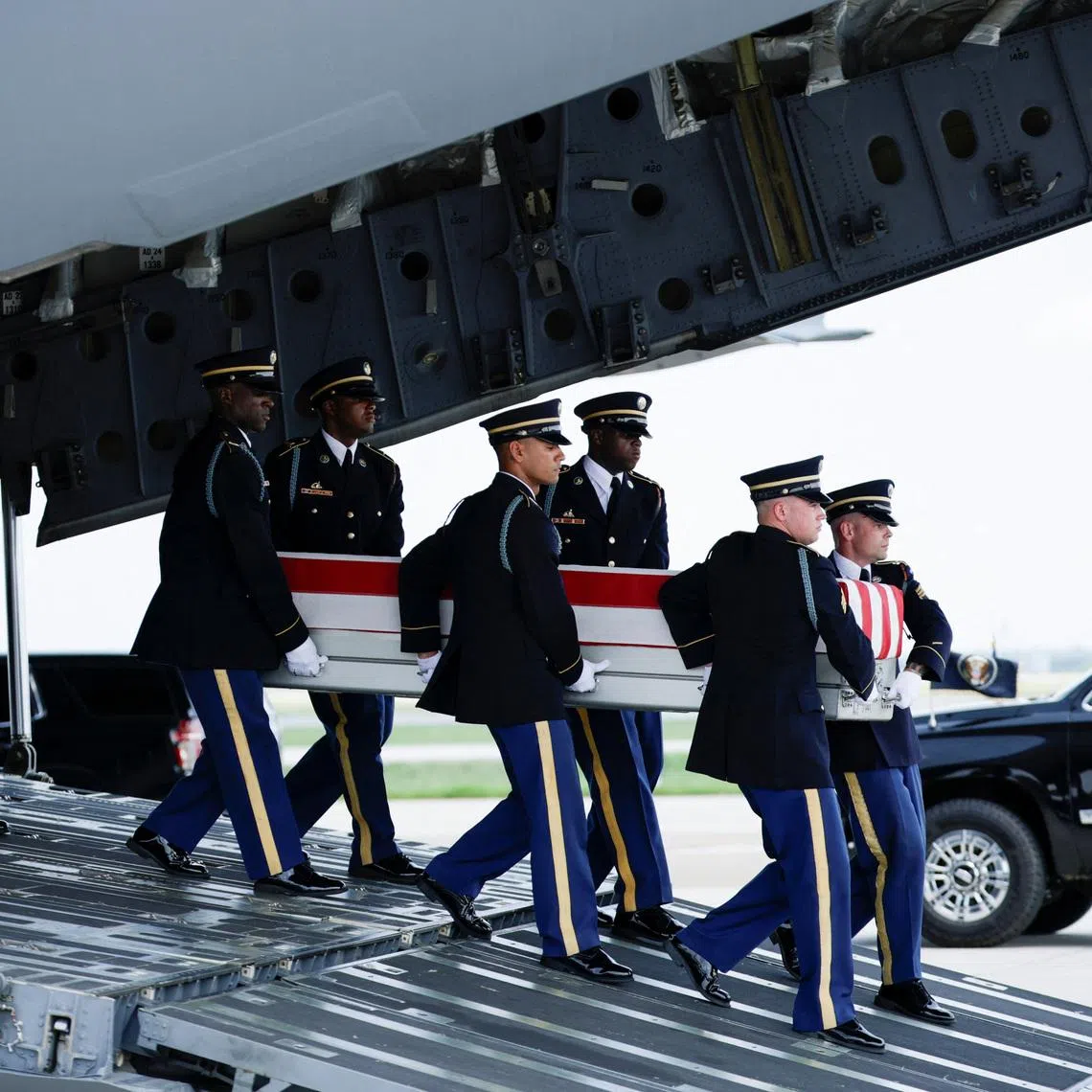 Members of the military carry the transfer case of US Army Sergeant Michael Emmanuel Swinton of D Battery, who was killed in action at Erbil Air Base in Iraq, on July 22.