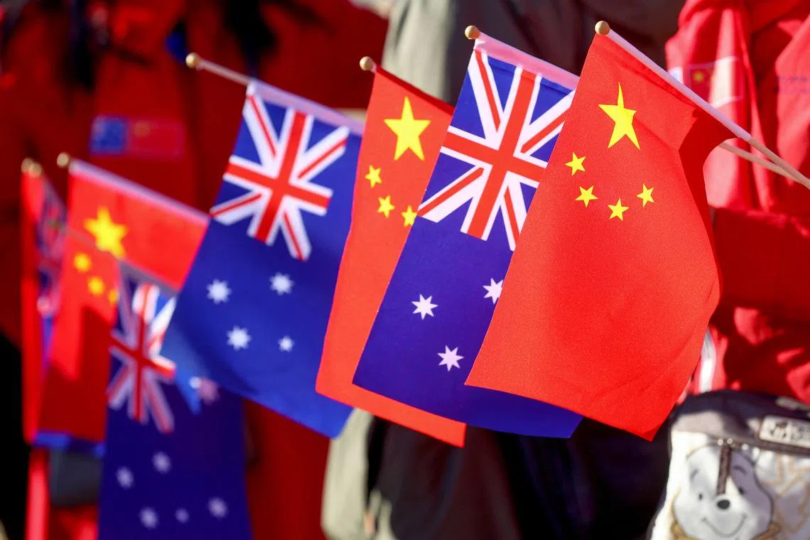 FILE PHOTO: Supporters of Chinese Premier Li Qiang hold Australian and Chinese flags as wait for his arrival at Magill Estate winery in Adelaide, Australia, Sunday, June 16, 2024. Li is on the second leg of a weeklong tour New Zealand, Australia and Malaysia.     Kelly Barnes/Pool via REUTERS/File Photo