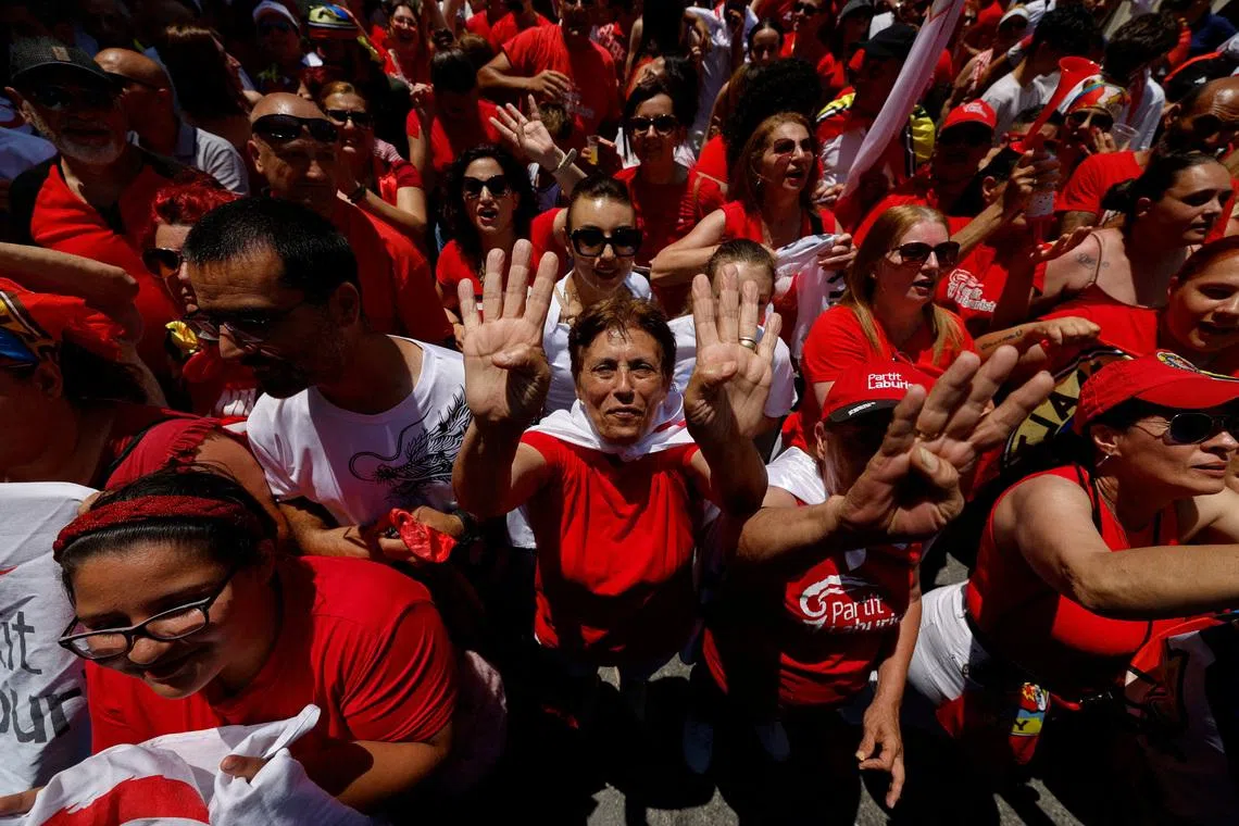 Supporters of Malta's Labour Party show four fingers, representing a record-breaking fourth consecutive term in power, amid celebrations as the party has claimed victory in the general election, outside the party headquarters in Hamrun, Malta May 31, 2026.  REUTERS/Darrin Zammit Lupi