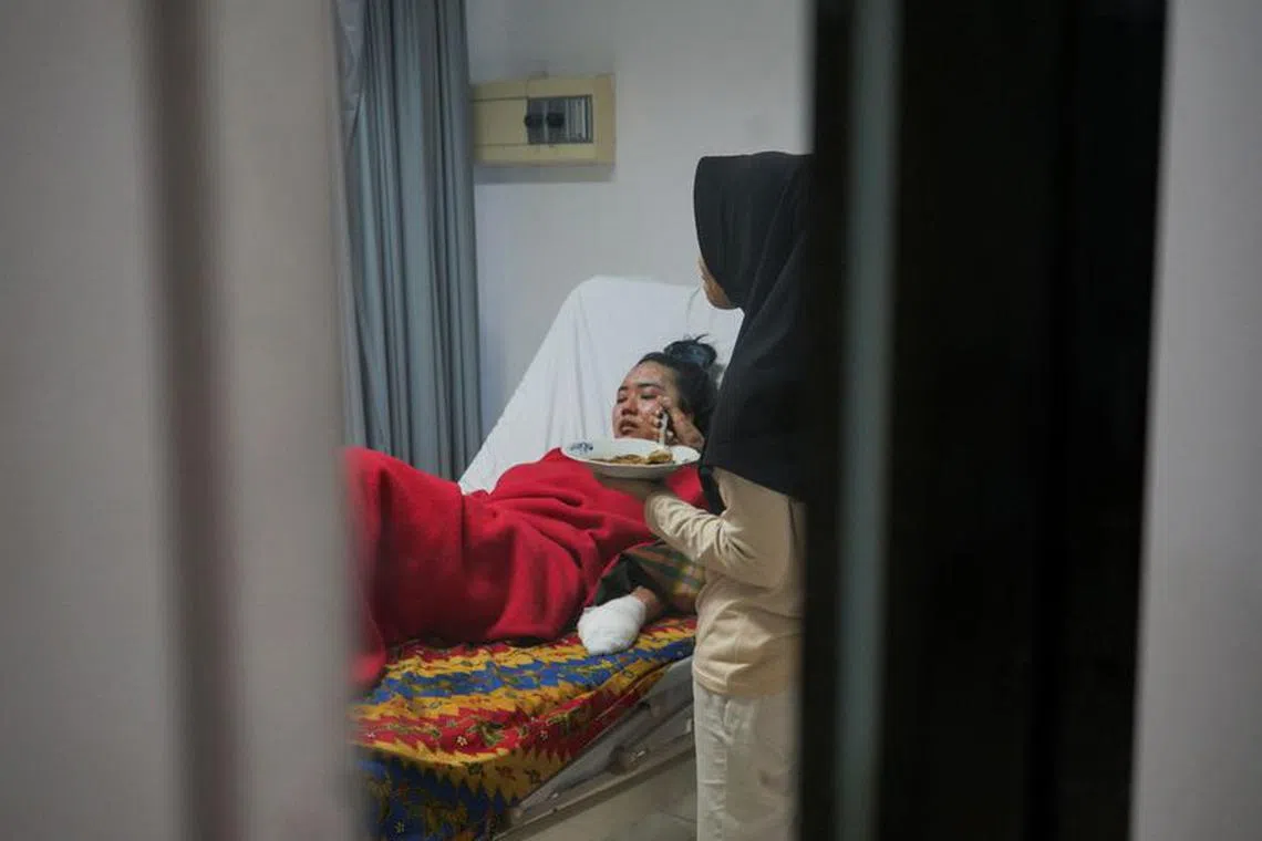 Tita Cahyani, a 25-year-old hiker who survived in Mount Marapi volcano eruption, rests while receiving treatment at a regional hospital in Padang Panjang, West Sumatra province, Indonesia, December 6, 2023. REUTERS/Rahmat Panji