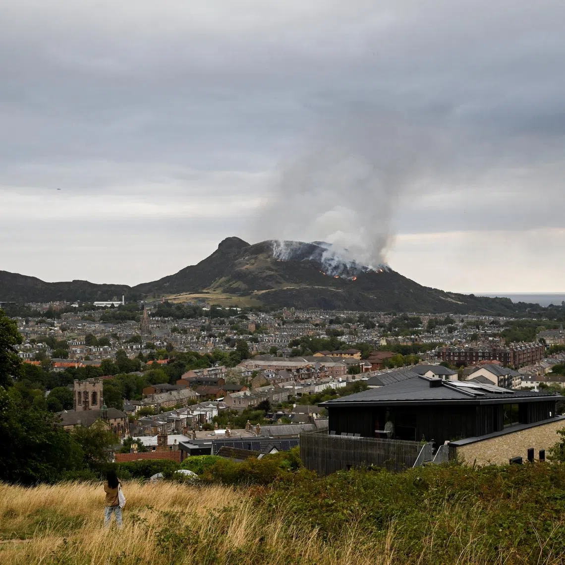 Smoke rises as a wildfire burns at Arthur's Seat in Edinburgh, Scotland, Britain, August 10, 2025. REUTERS/Lesley Martin